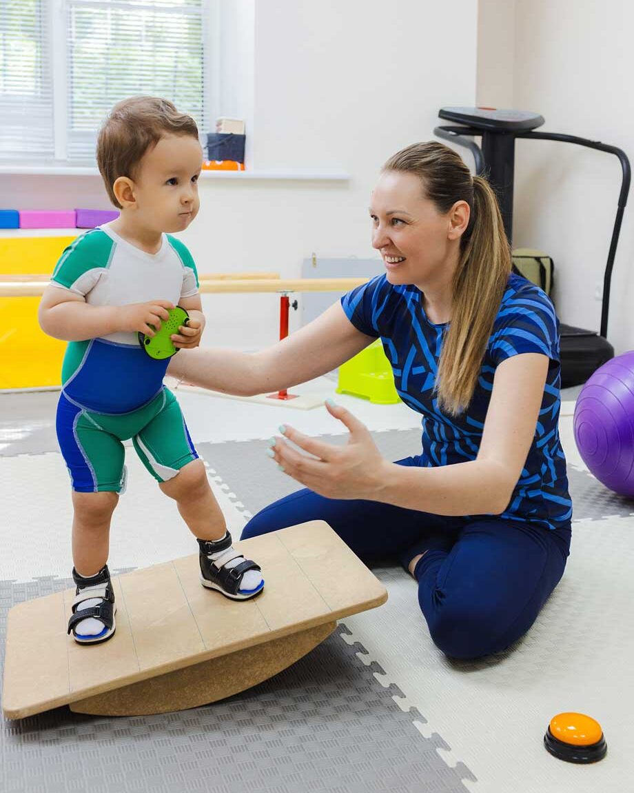 Child balance training and coordination on a rehabilitation balancer and rehabilitation center. Autism services