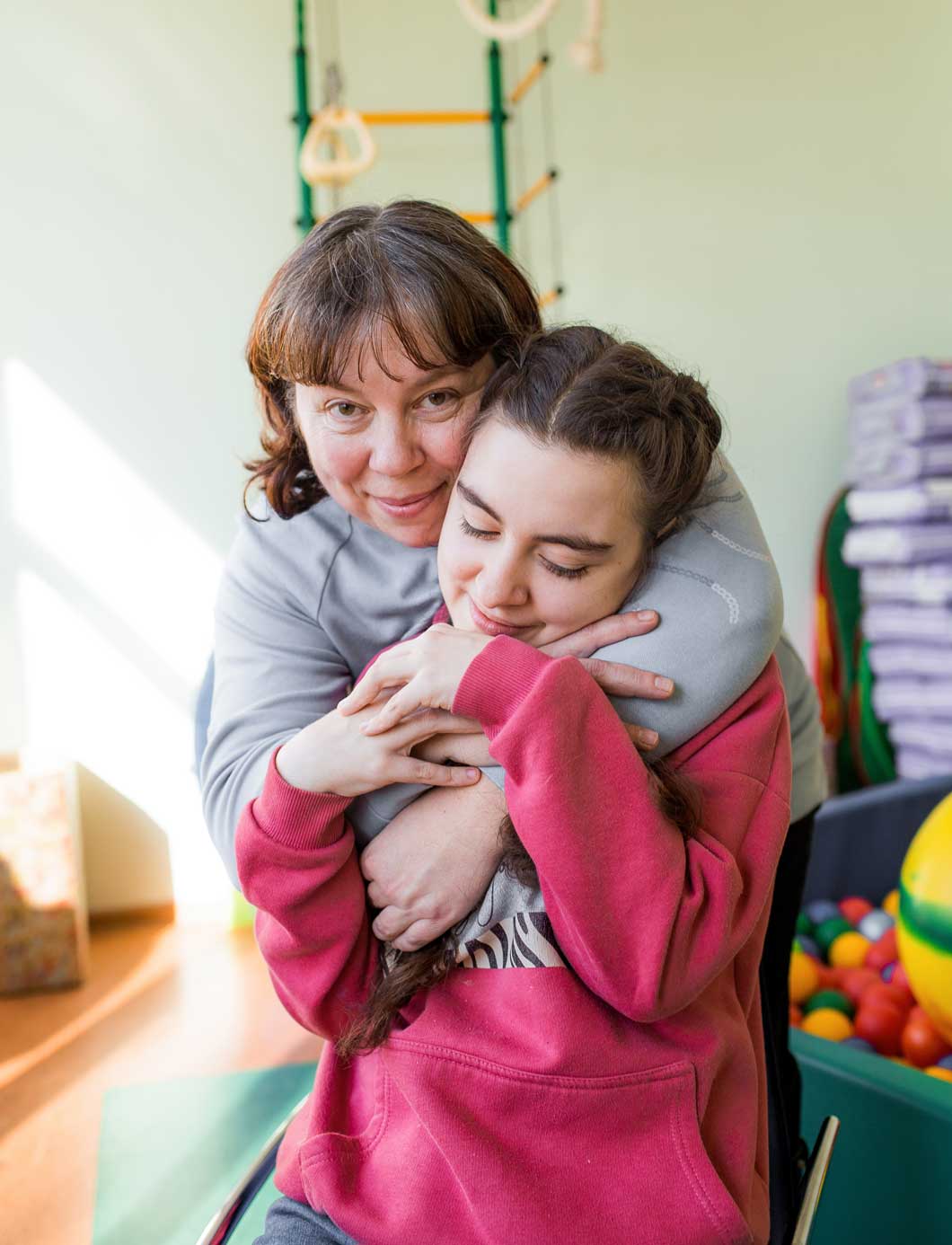 a girl diagnosed with autism with her mother in a rehabilitation center