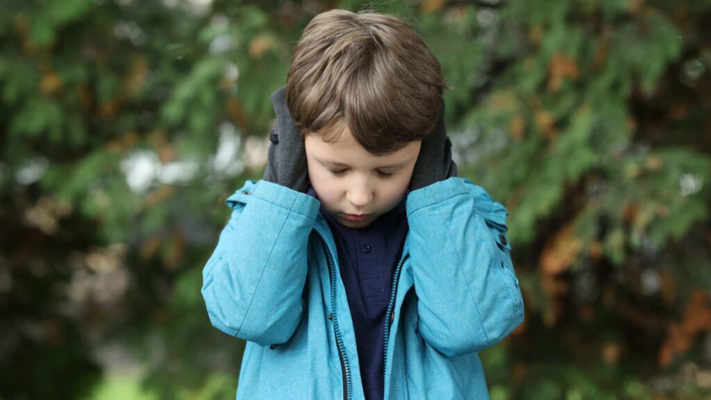 Kid showing autism signs including sensory overload