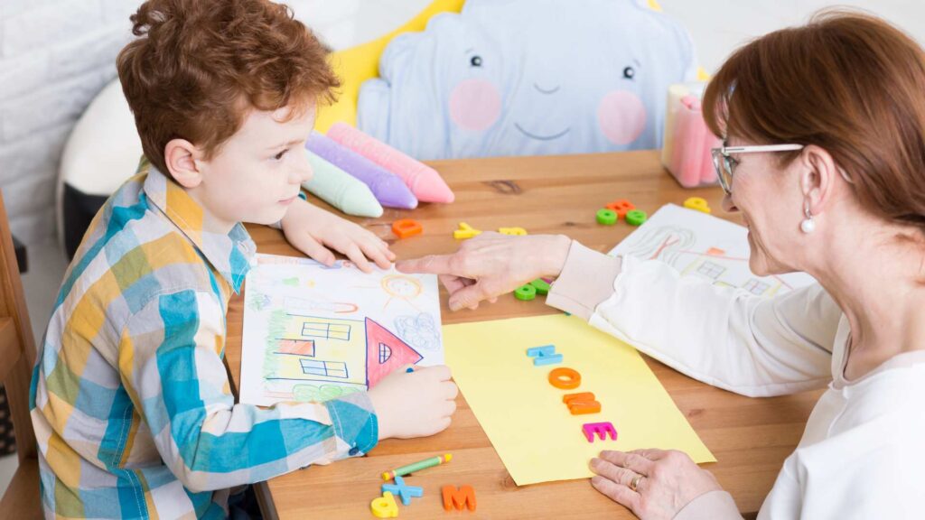 A child and an ABA professional engaging in a playful learning moment that reflects the BCBA Role in ABA therapy.