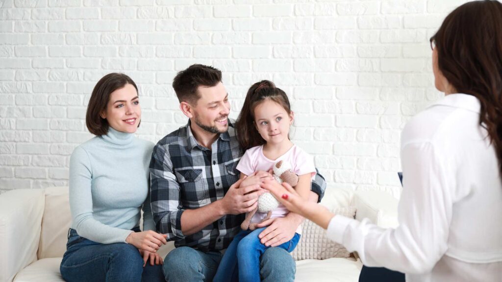 A family meeting with an ABA professional, showing how the BCBA role brings parents into the process through helpful coaching