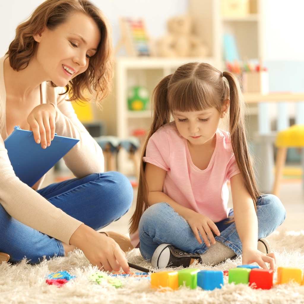 A RBT role in ABA therapy, where a professional guides a young child through play activities