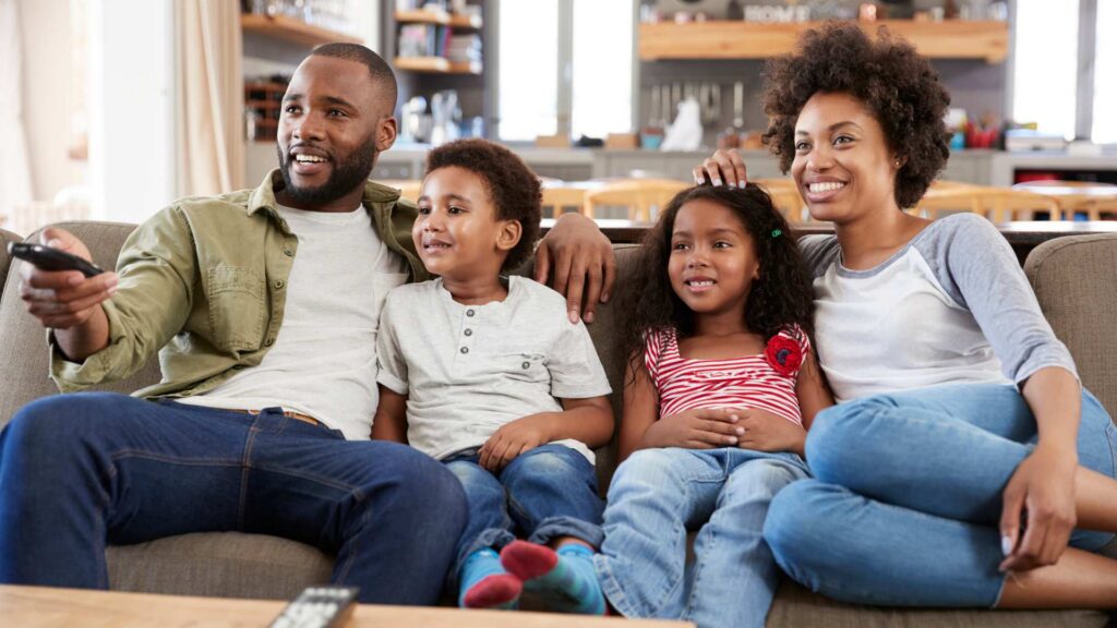 A family watching TV together, showing how autism representation in media can shape everyday conversations