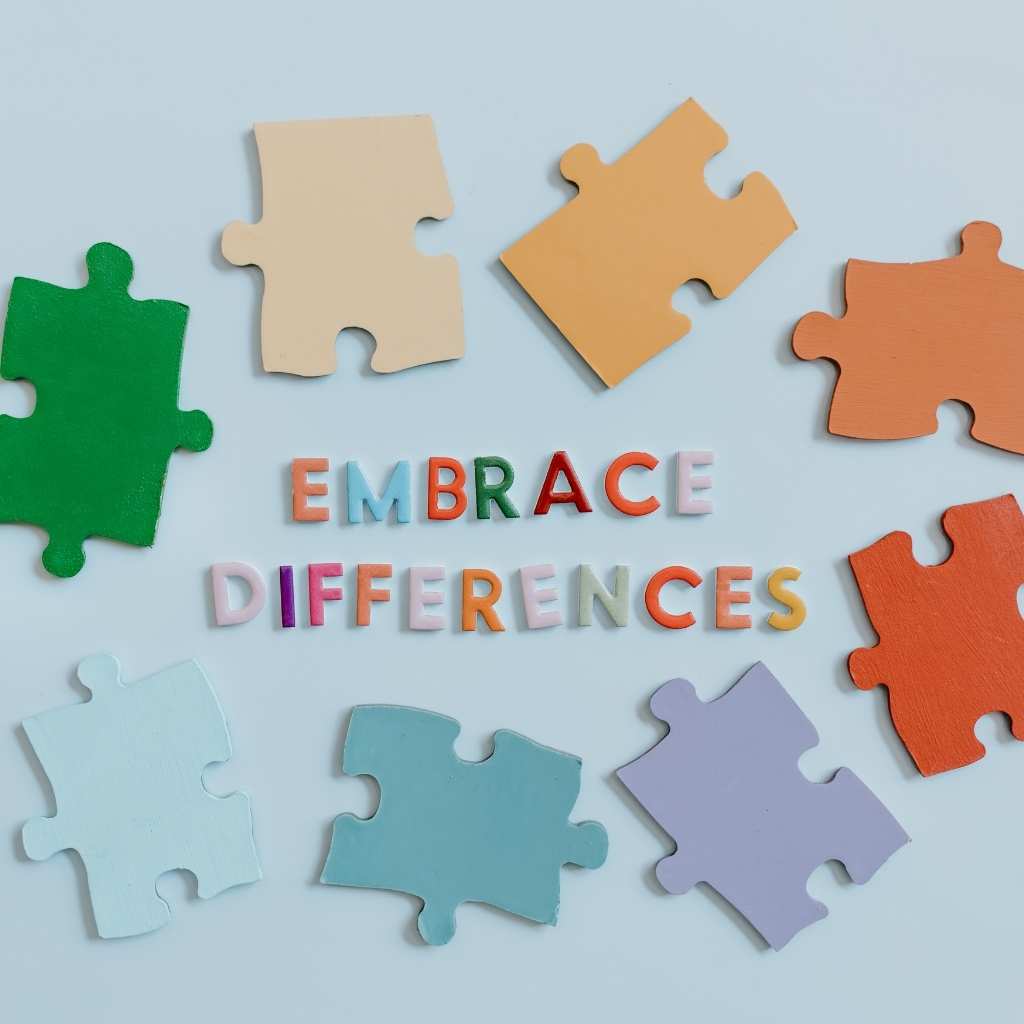Puzzle pieces around the phrase Embrace Differences, used to support autism acceptance and acknowledge the role of celebrities with autism in the community