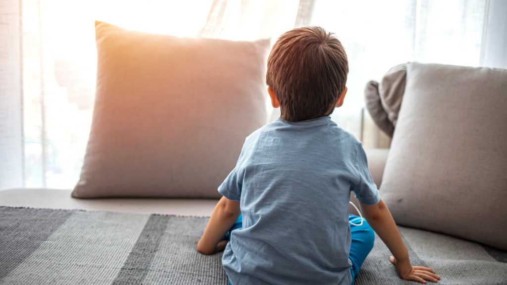 Autism Day child sitting alone reflecting autism acceptance and early support